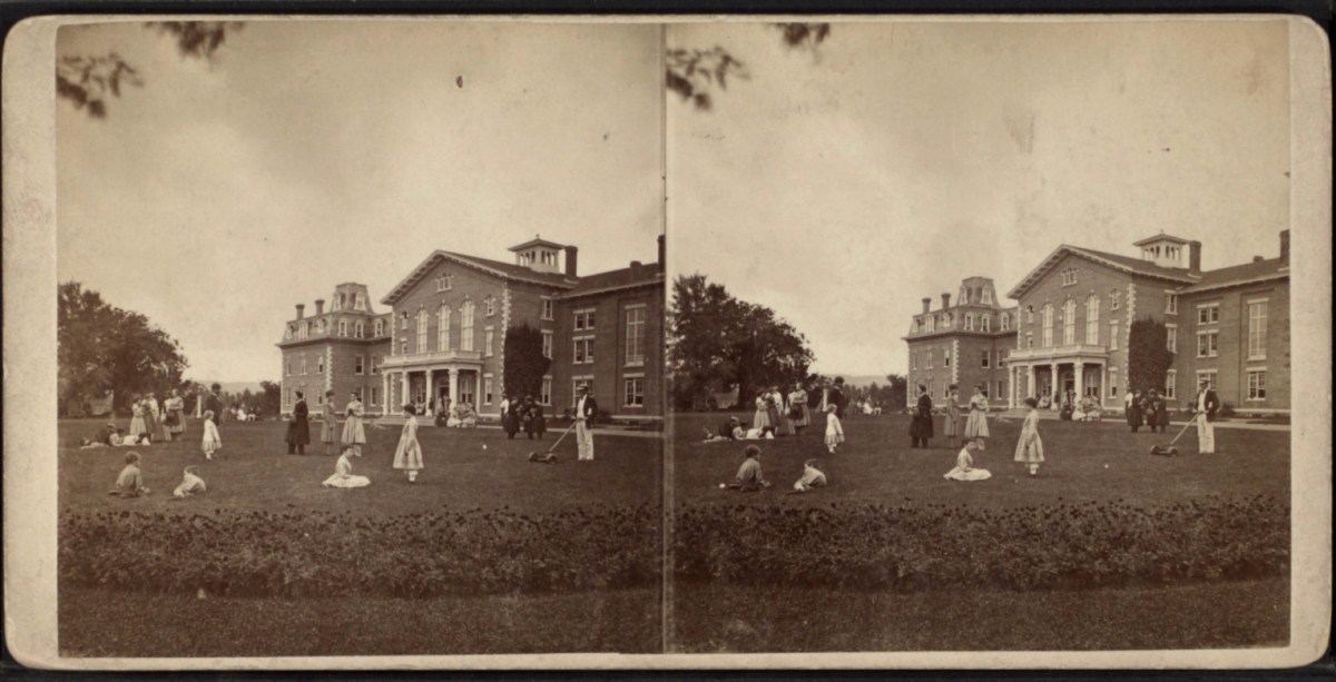 A photo of a group of people in front of a building.