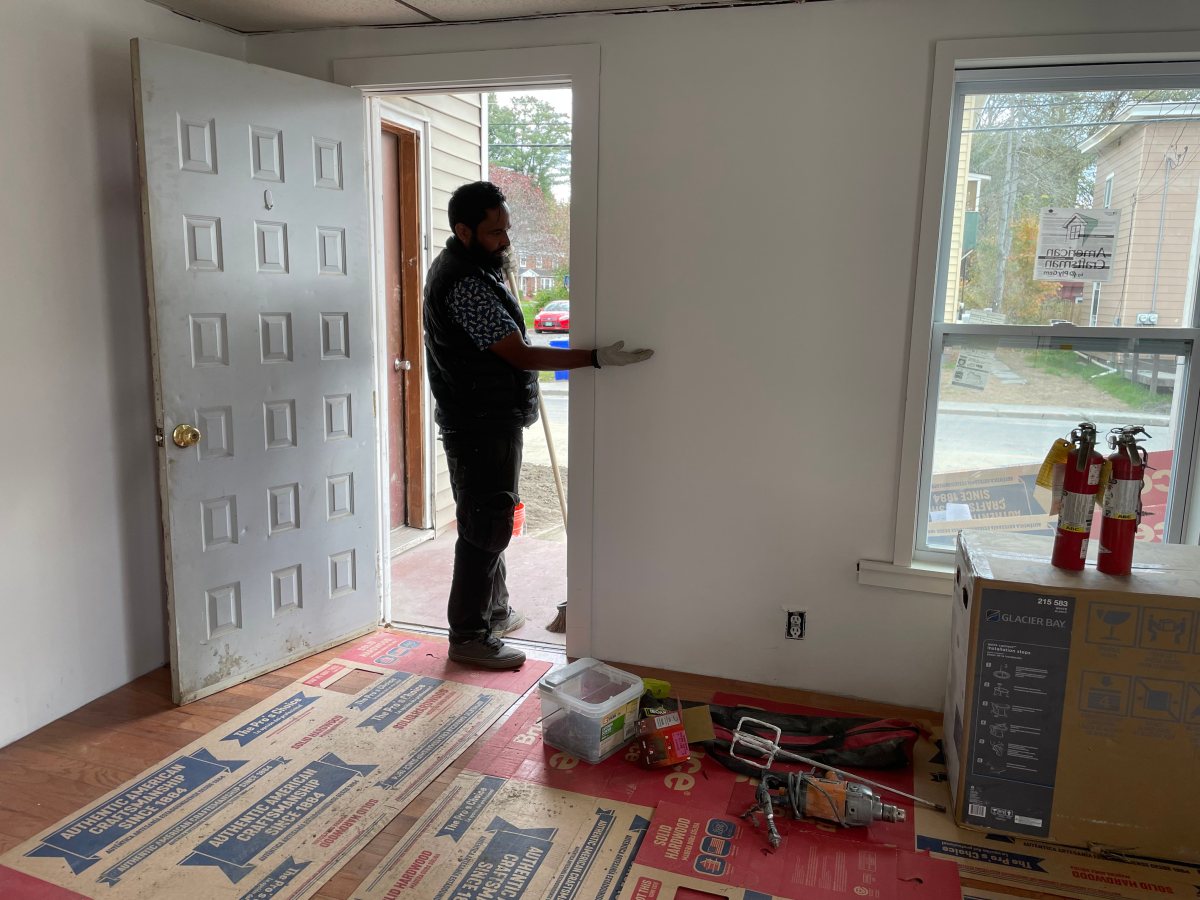 A man standing in the doorway of a room.