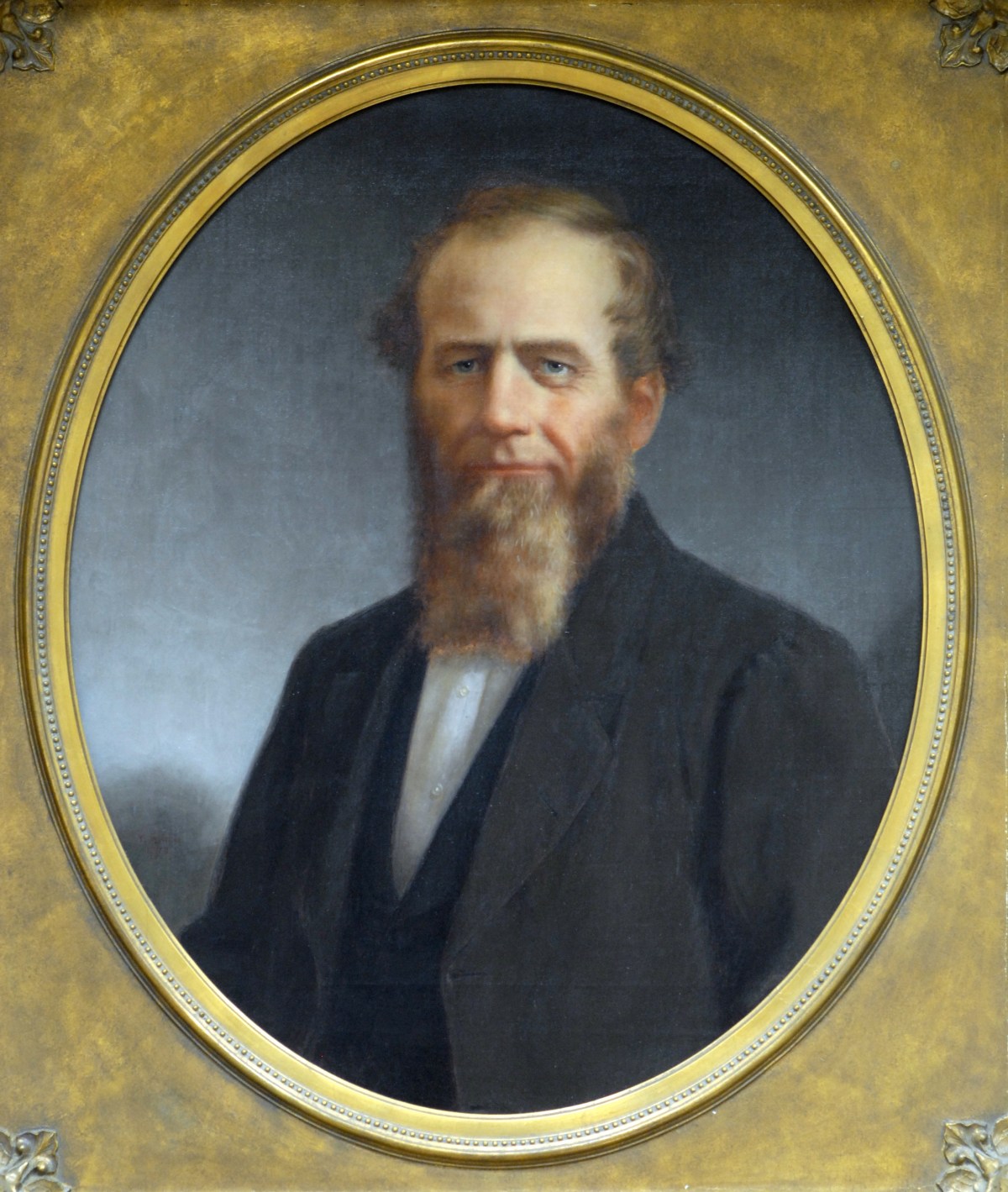 A portrait of a man with a beard.