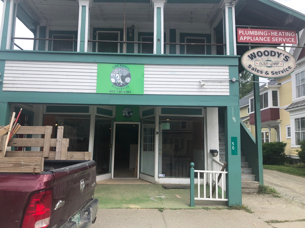 A truck is parked in front of a building.