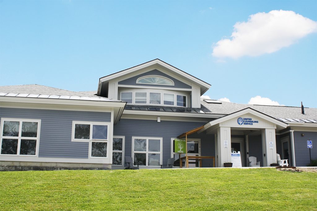 The exterior of a home with a blue roof.