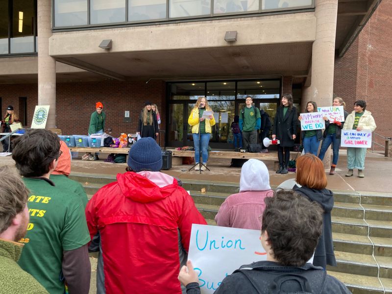 A group of people holding signs in front of a building.