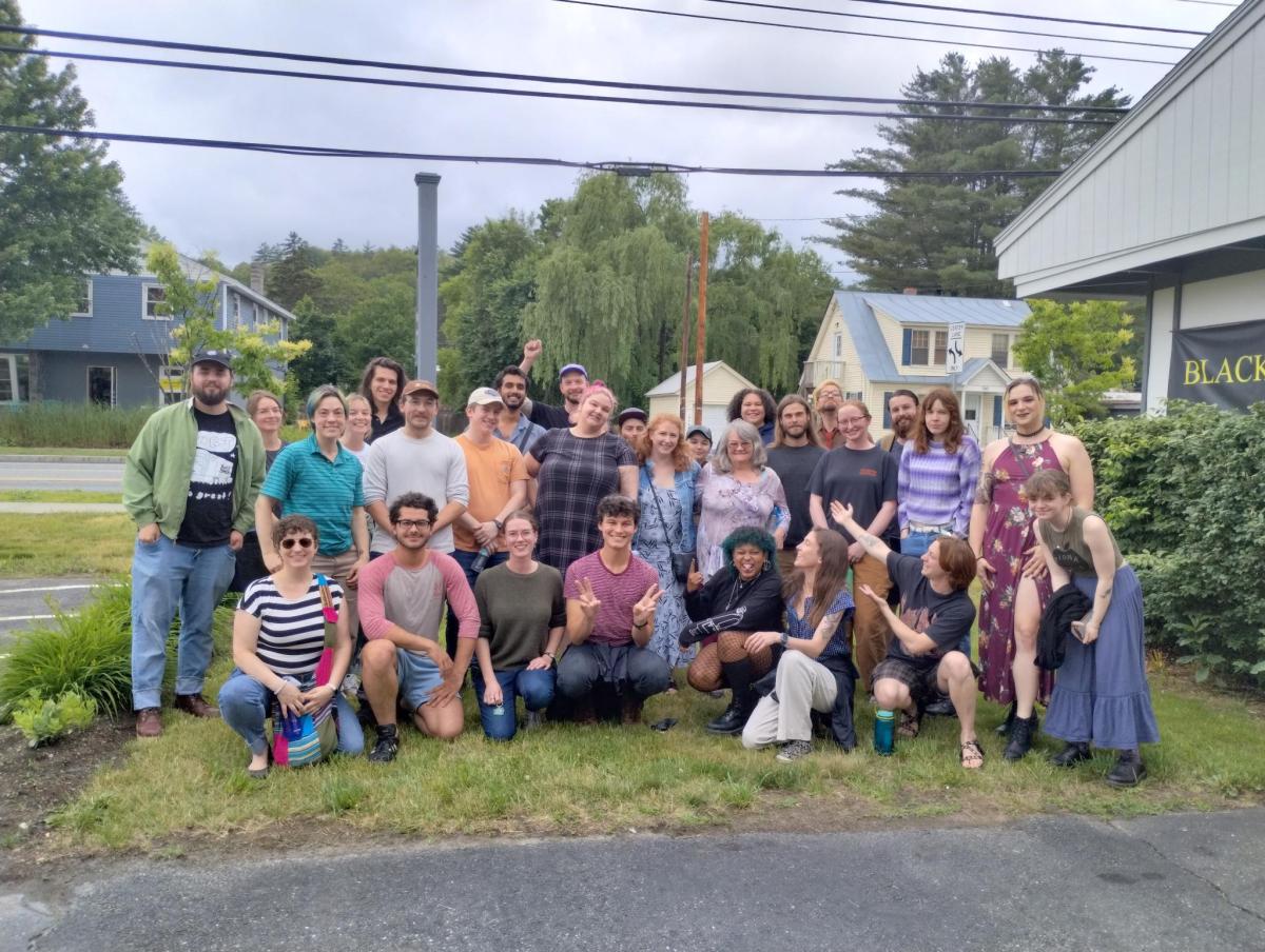 a group of people posing for a picture in front of a house.