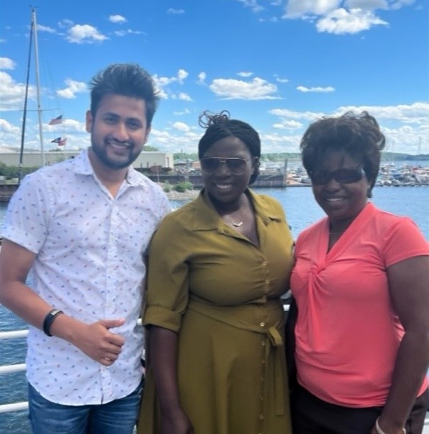Three people posing for a photo on a boat.