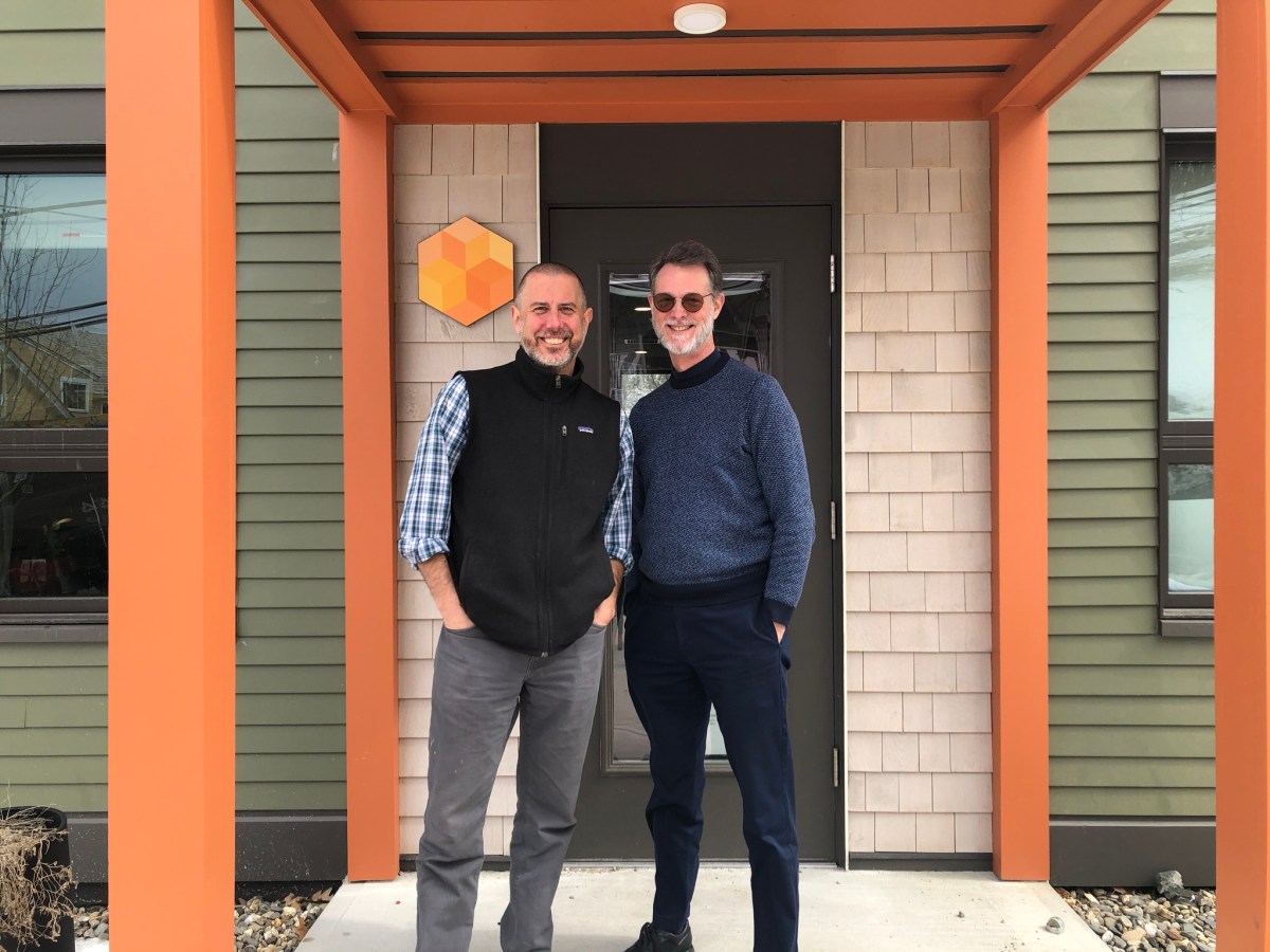 Two men standing in front of a building.