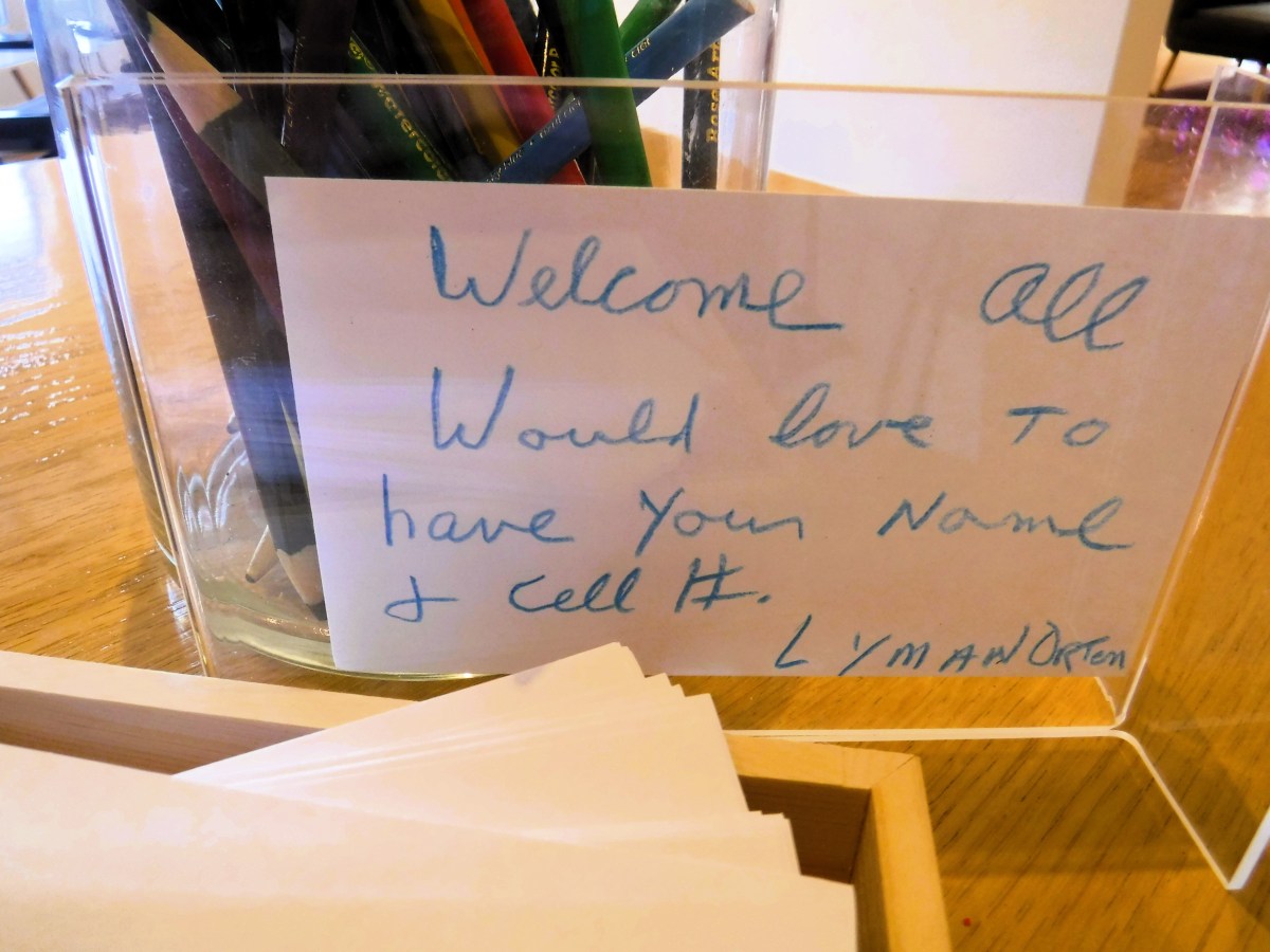 A sign on a table that says welcome all.