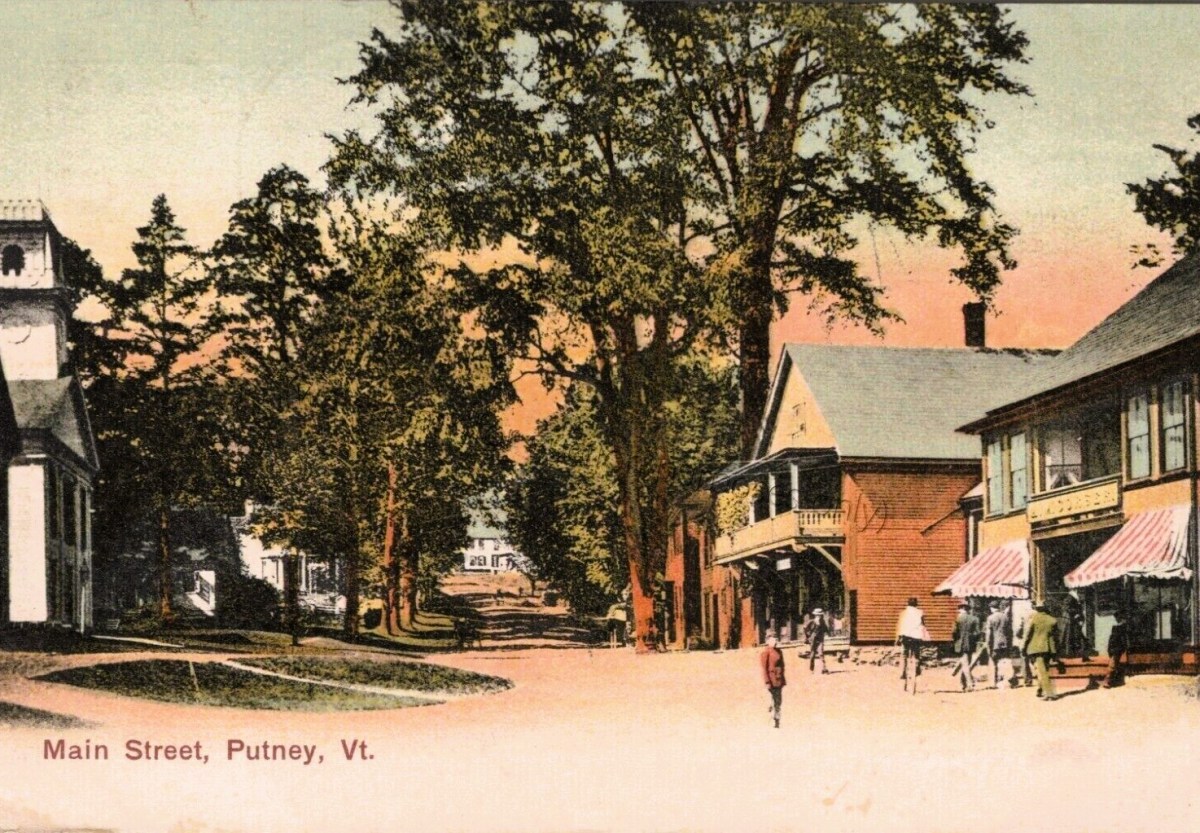 A postcard showing a street in a small town.