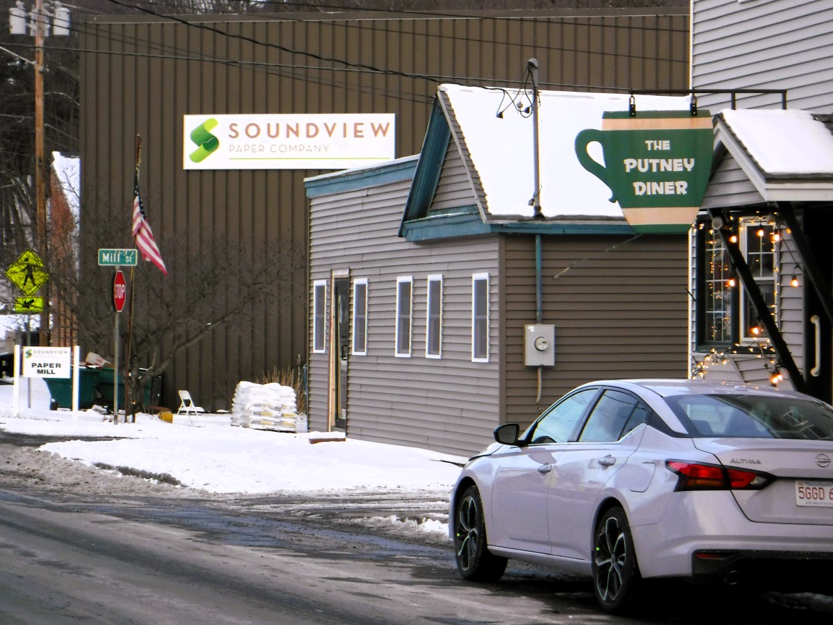 A white car parked on a snowy street.