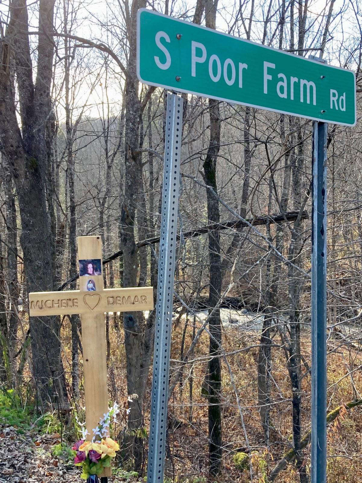 A sign for S. Poor Farm Road and a cross for Michele Demar.