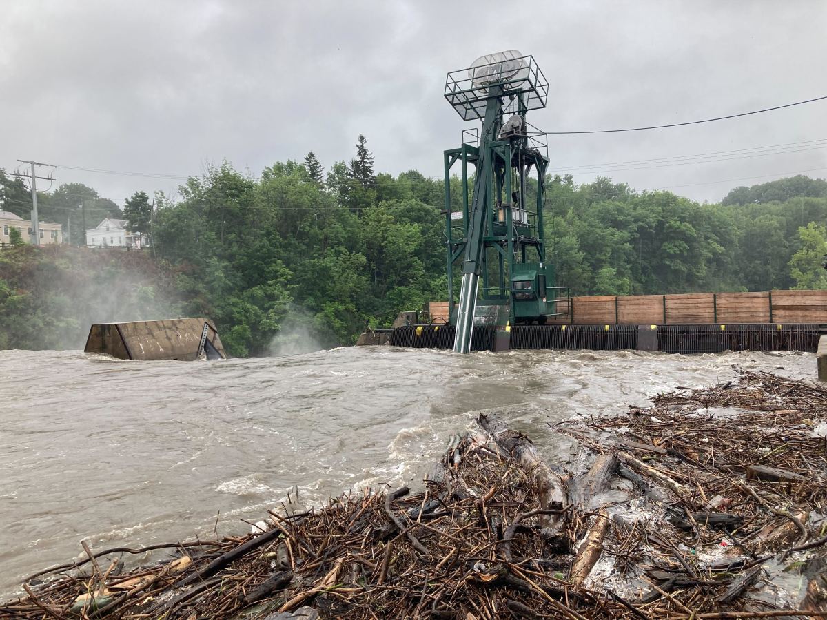 a flooded river with a crane in the middle of it.