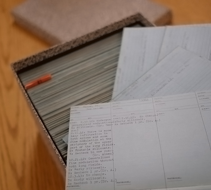 A box filled with papers on a table.