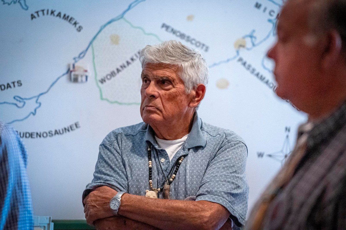 A group of men standing in front of a map.