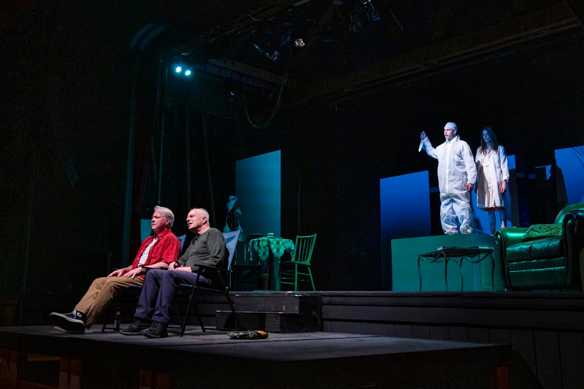 a group of people sitting on top of a stage.