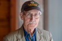 an older man wearing a hat and glasses.