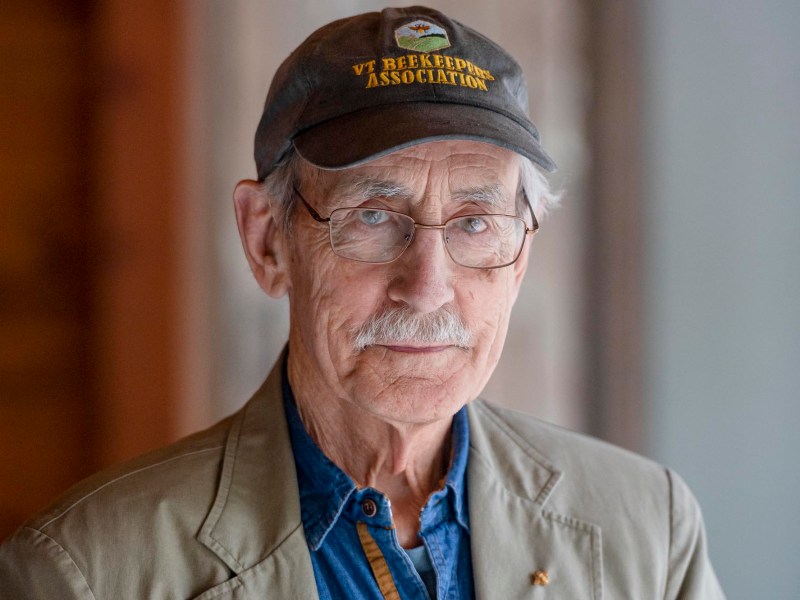 an older man wearing a hat and glasses.