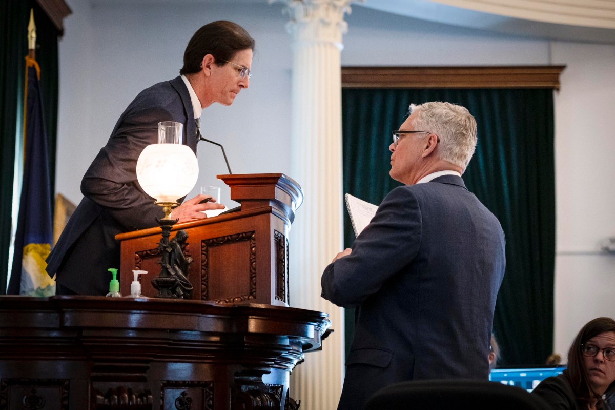 Two men in suits standing at a podium.