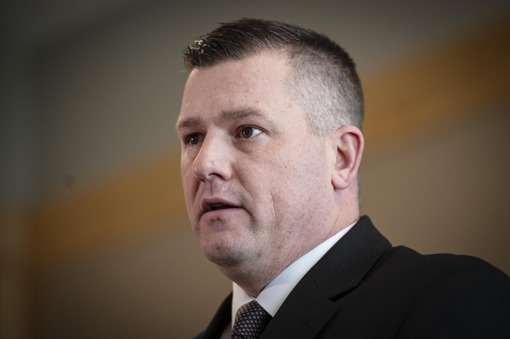 Man in suit giving a speech.