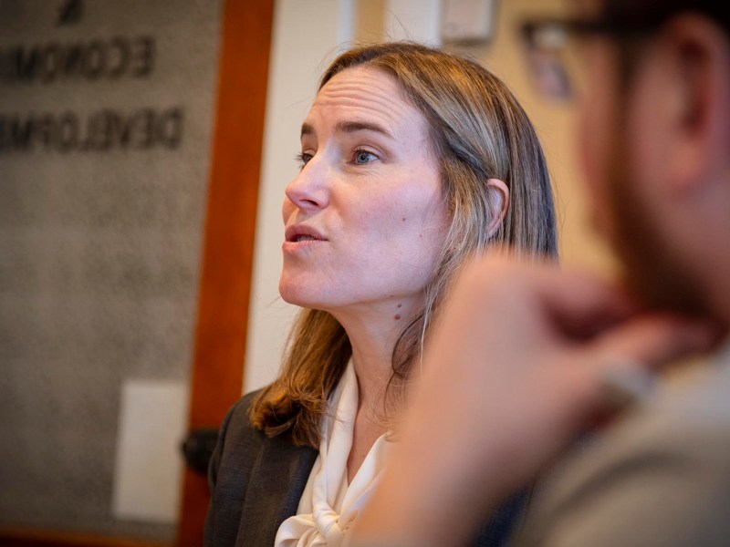 A woman in a business suit talking.