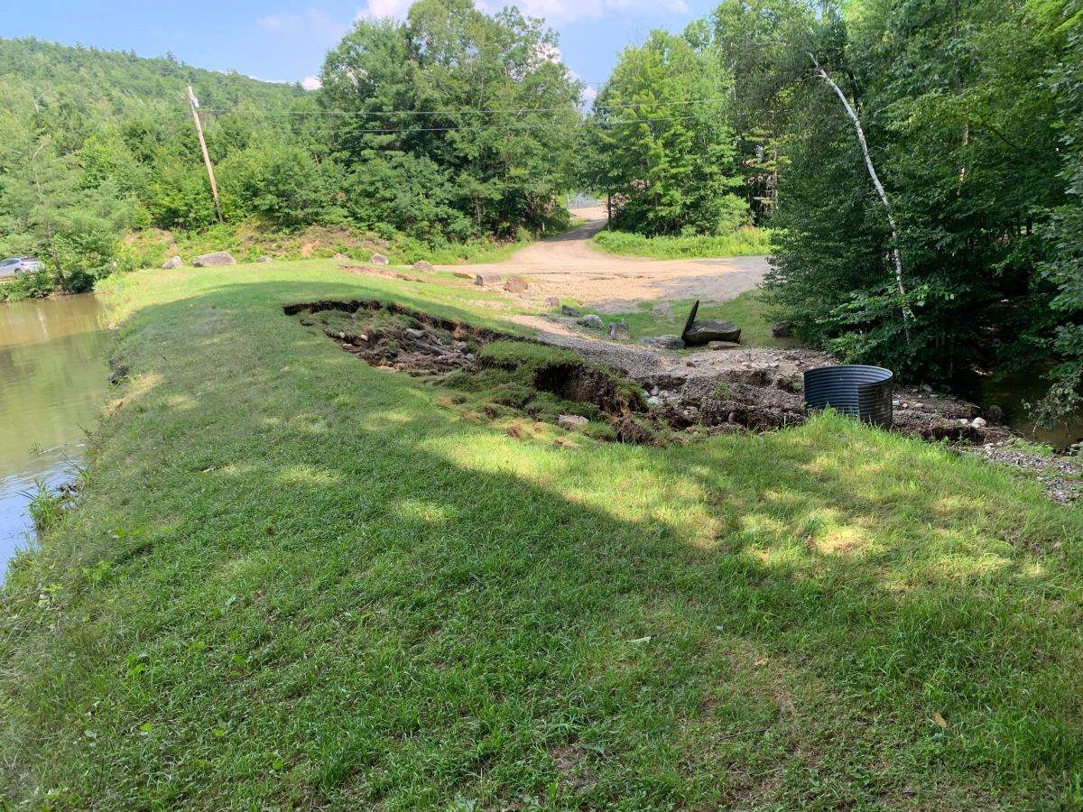 the bank of a river with a boat on it.