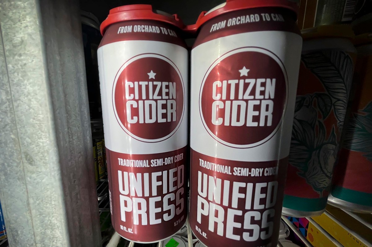 Two cans of citizen cider on a shelf.