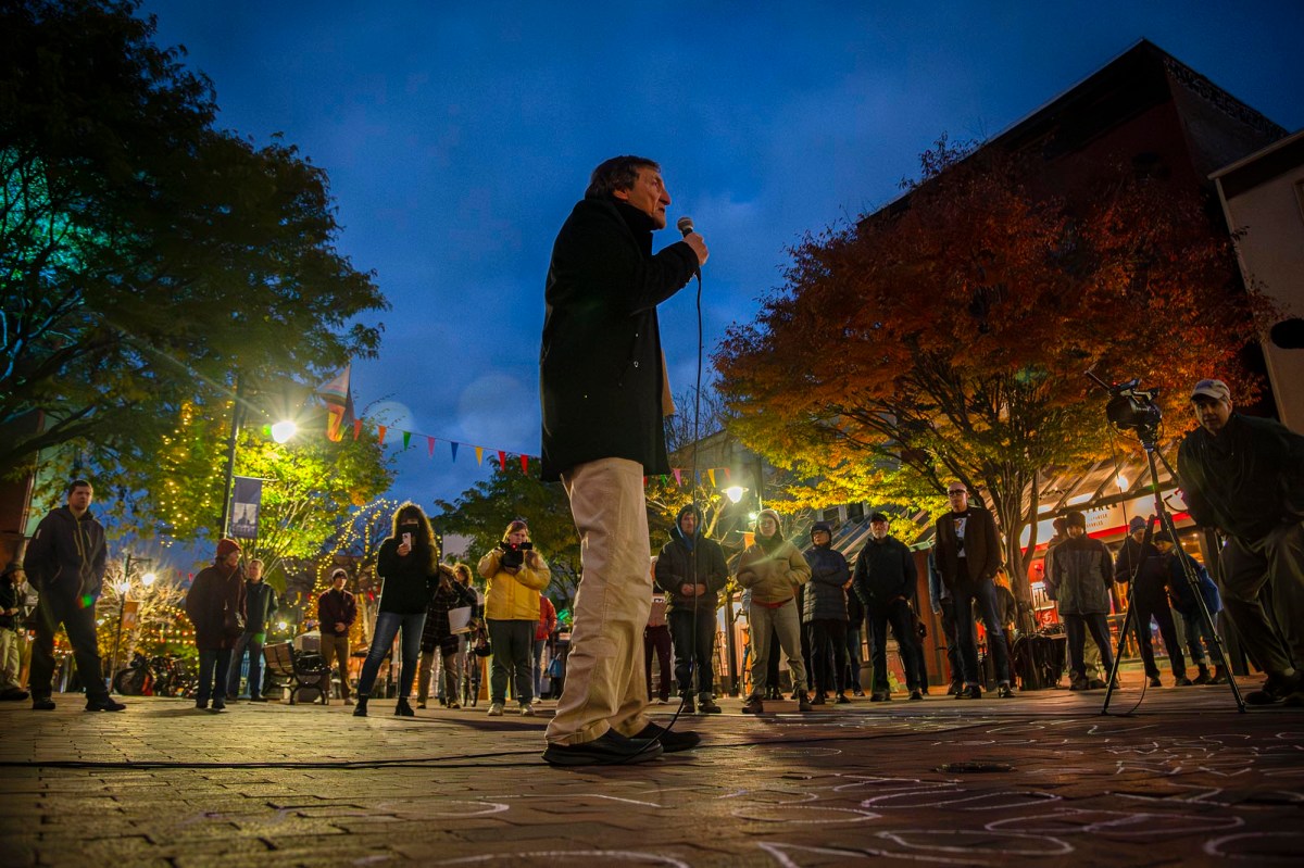 A man is standing in front of a crowd of people.