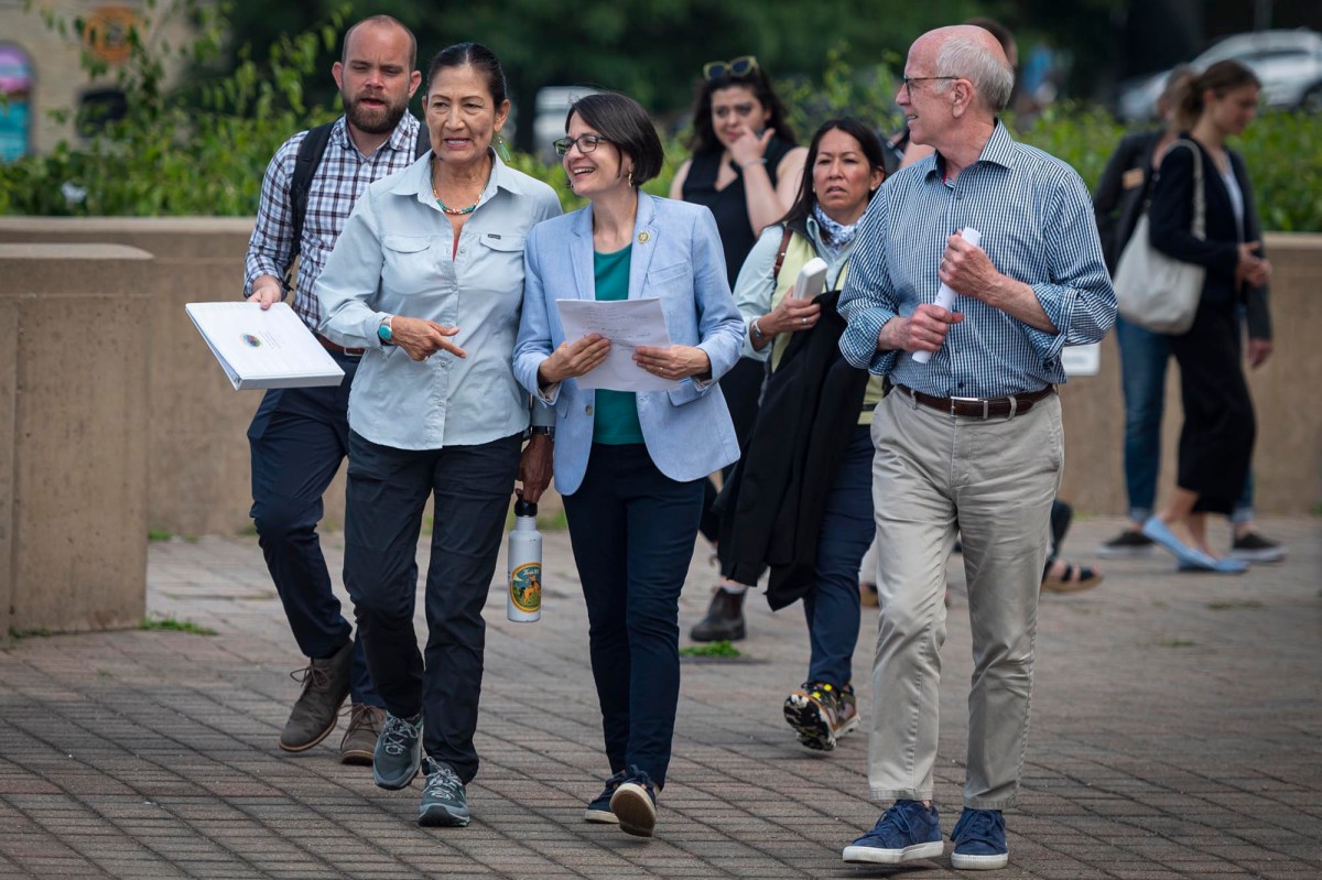 a group of people walking down a sidewalk.