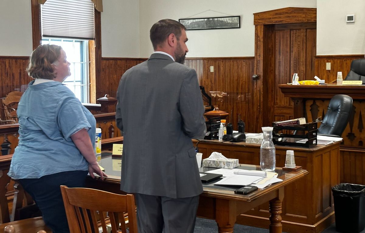 a man and woman standing in a courtroom.