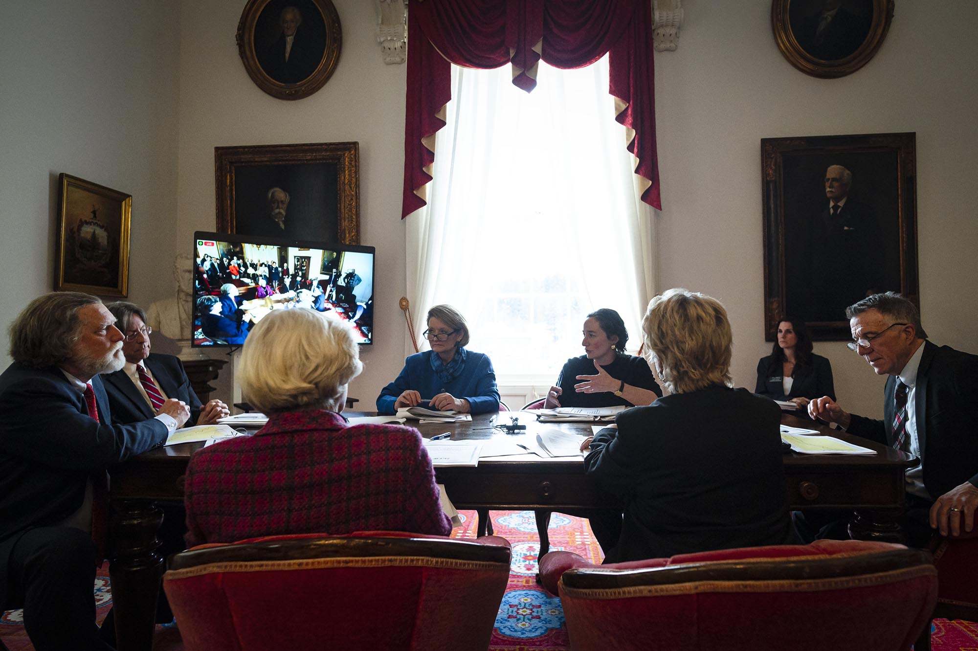A group of people sitting around a table.