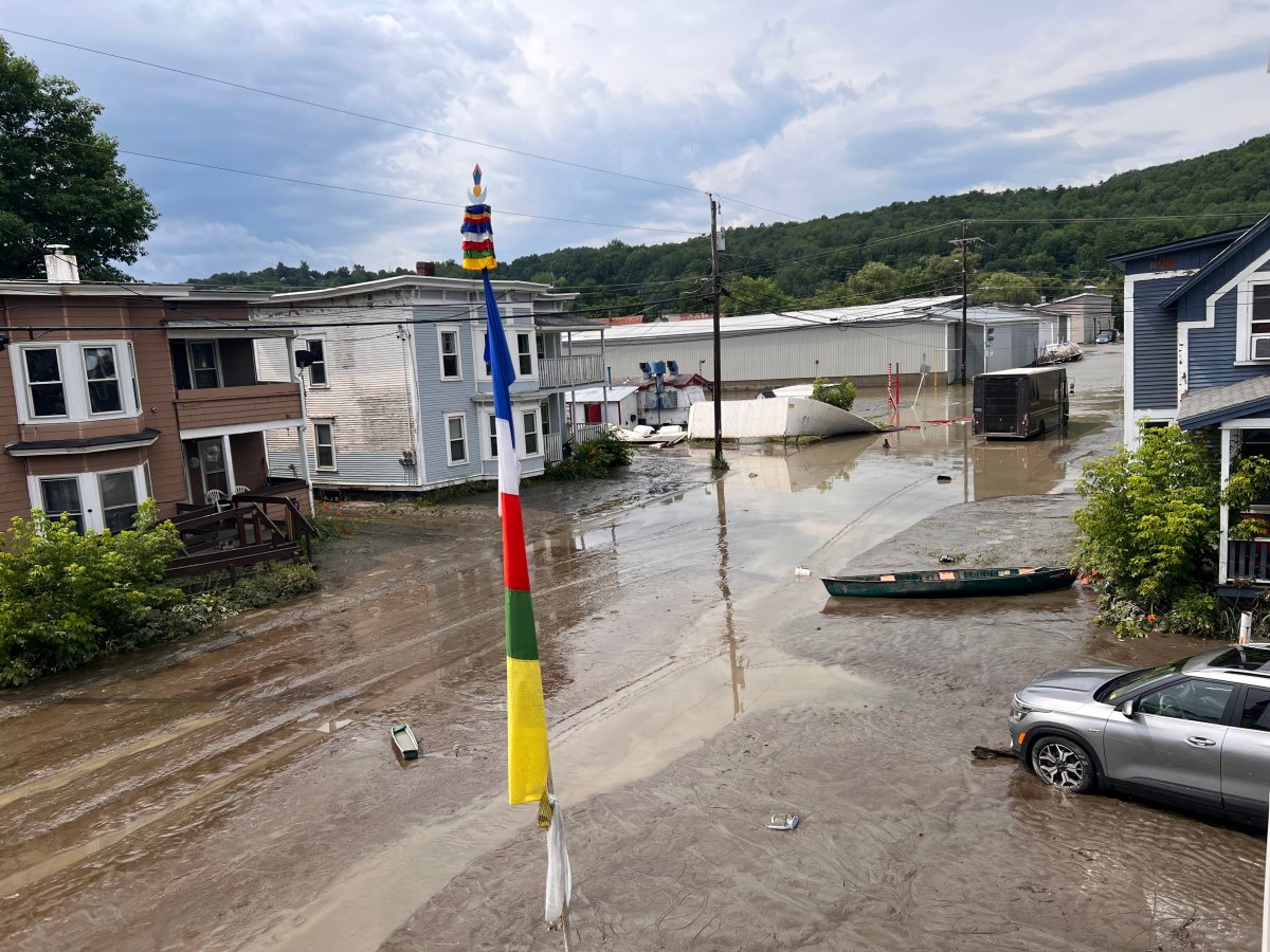 A car is parked in a flooded street.