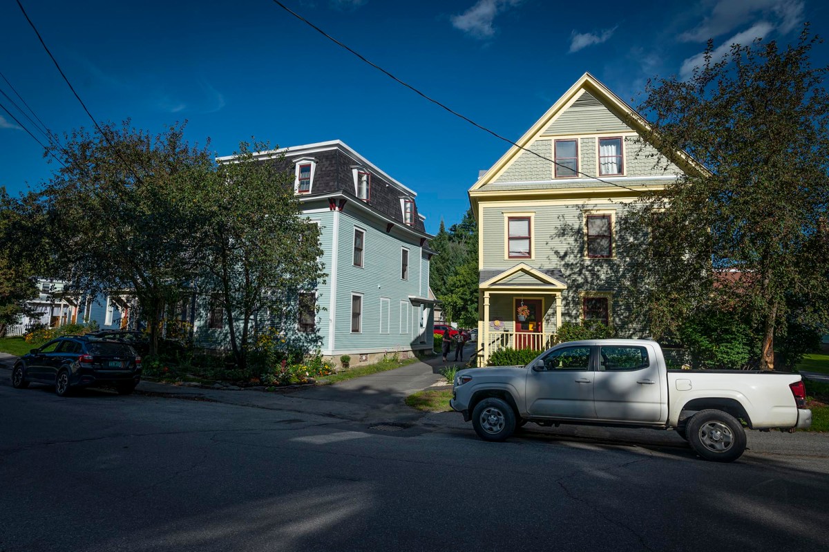 A truck is parked in front of a house.