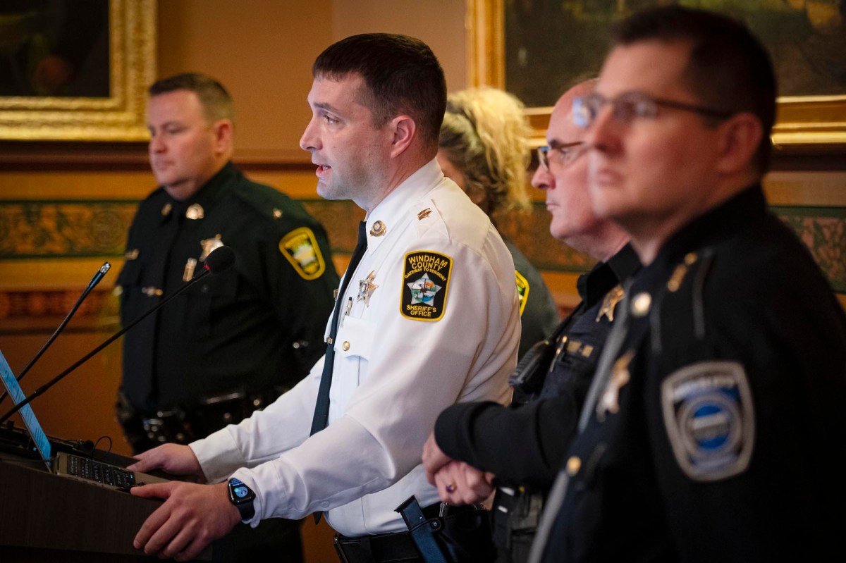 A group of police officers standing in front of a podium.