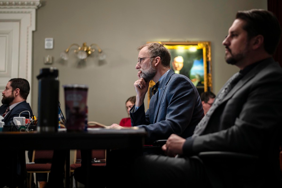 A group of people sitting at a table in a room.