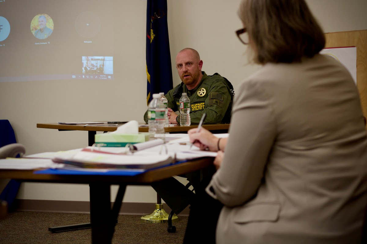 A man answers questions from a lawyer.