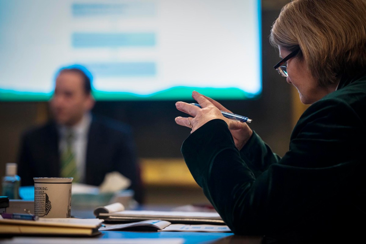 A woman sitting at a conference table.