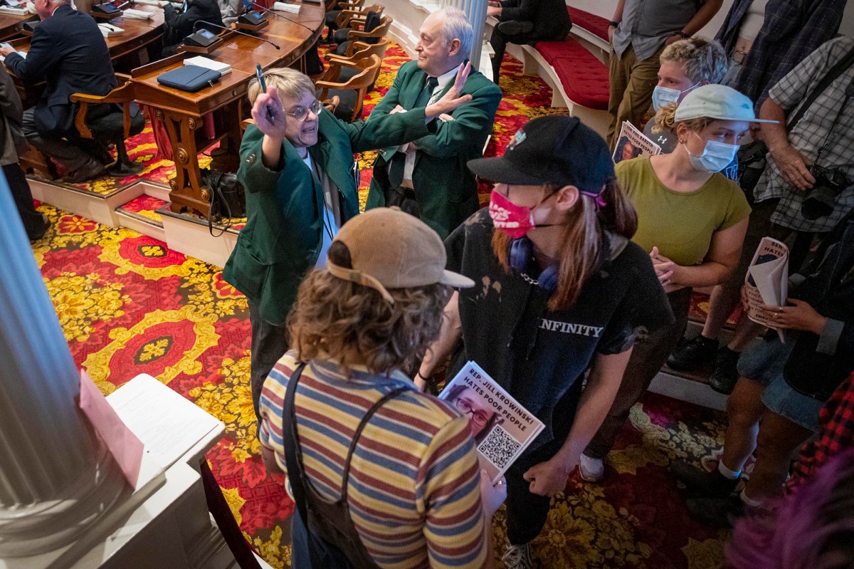 a group of people standing in a room.