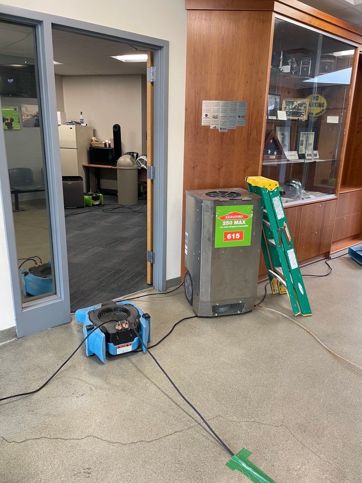 A vacuum cleaner is being used to clean the floor of an office.