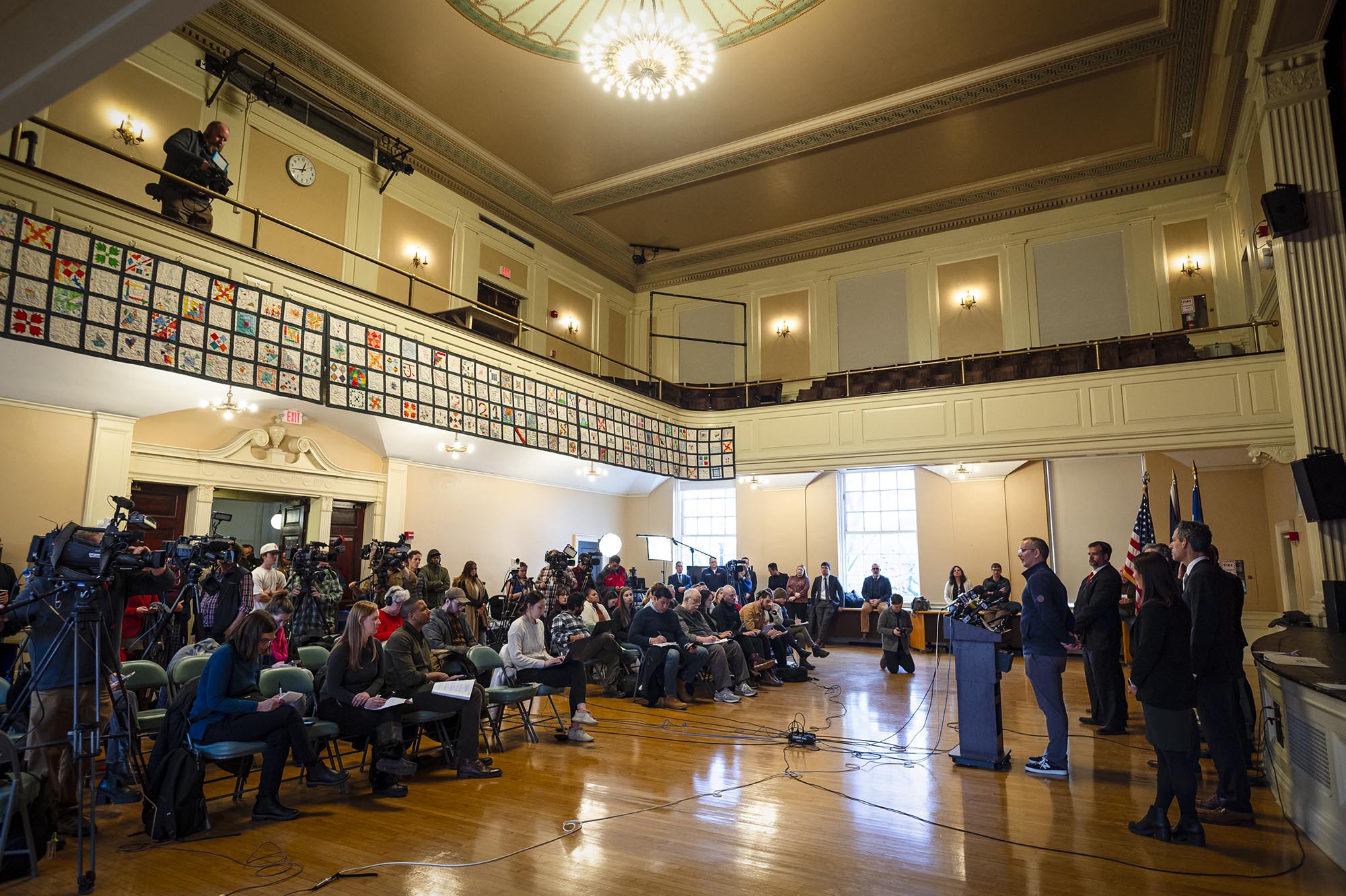 A group of people standing in front of a large room.