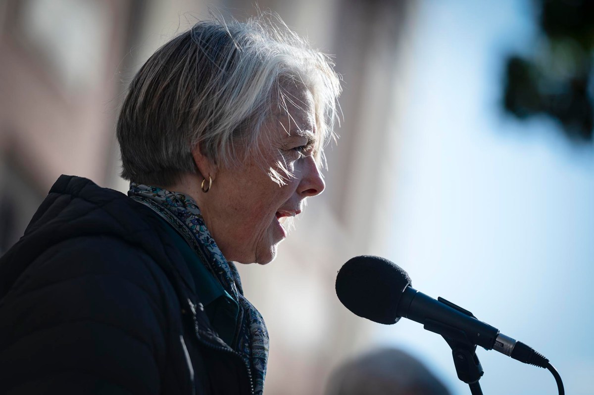 An woman speaking into a microphone.
