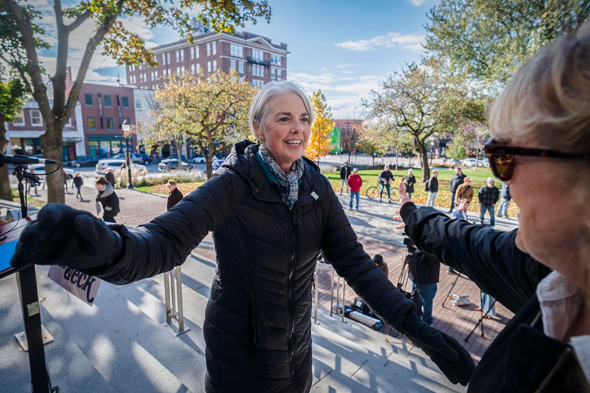 A woman in a black jacket is standing next to a woman in a black jacket.