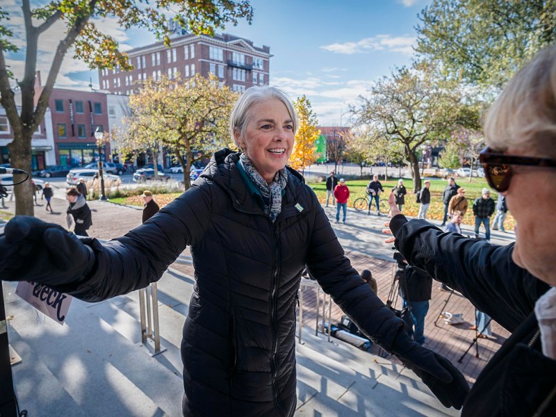 A woman in a black jacket is standing next to a woman in a black jacket.