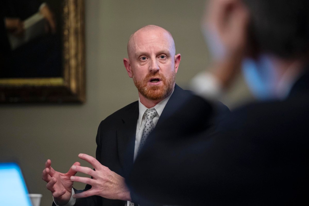 A man in a suit sitting at a table.