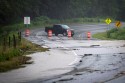 a truck is driving down a flooded road.