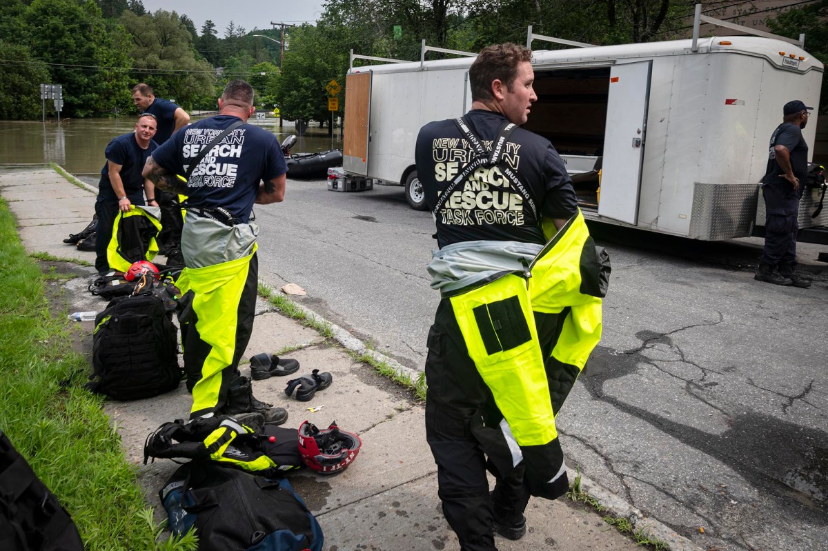 a group of people standing on the side of the road.