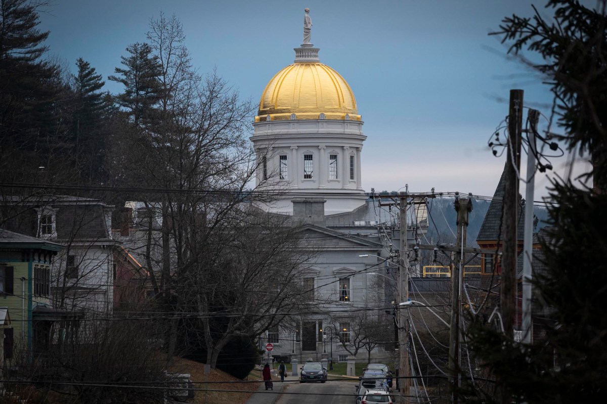 A building with a gold dome in the middle of a street.