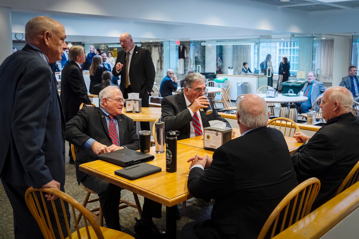 A group of men sitting around a table in an office.