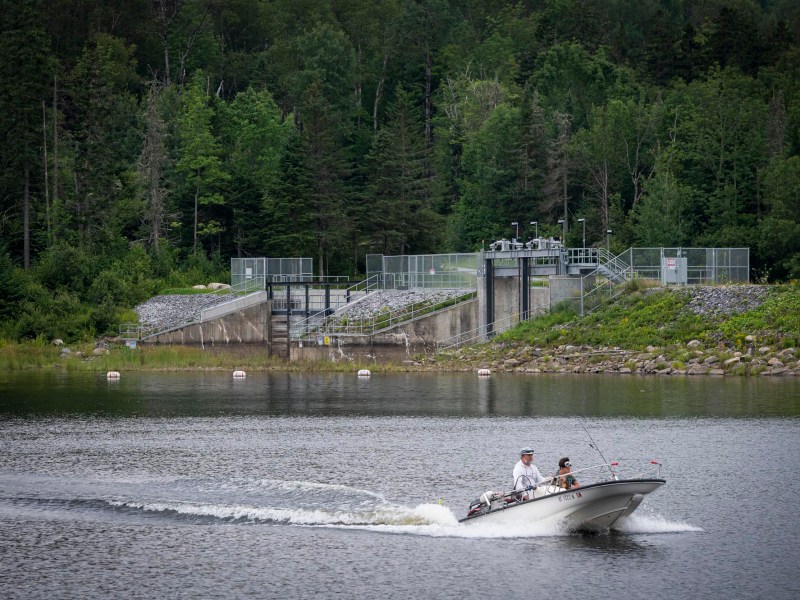 A man is riding a boat on a lake.
