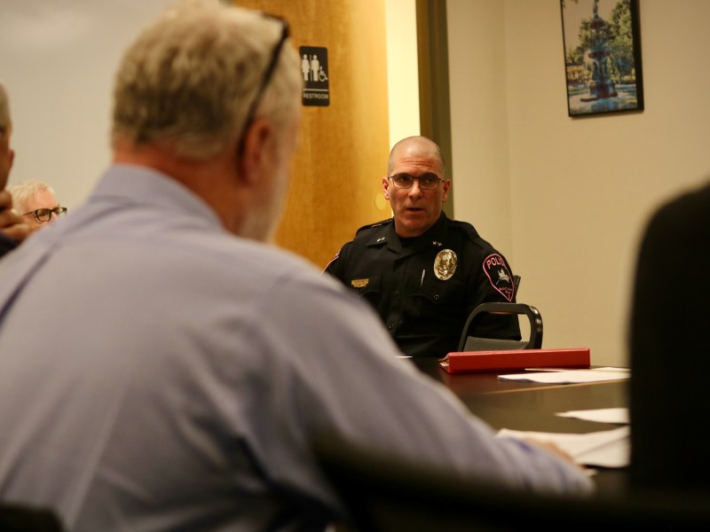 A group of police officers sitting around a table.