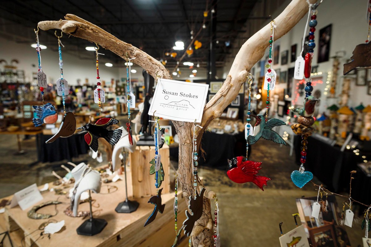 A wooden tree with a lot of items on it.