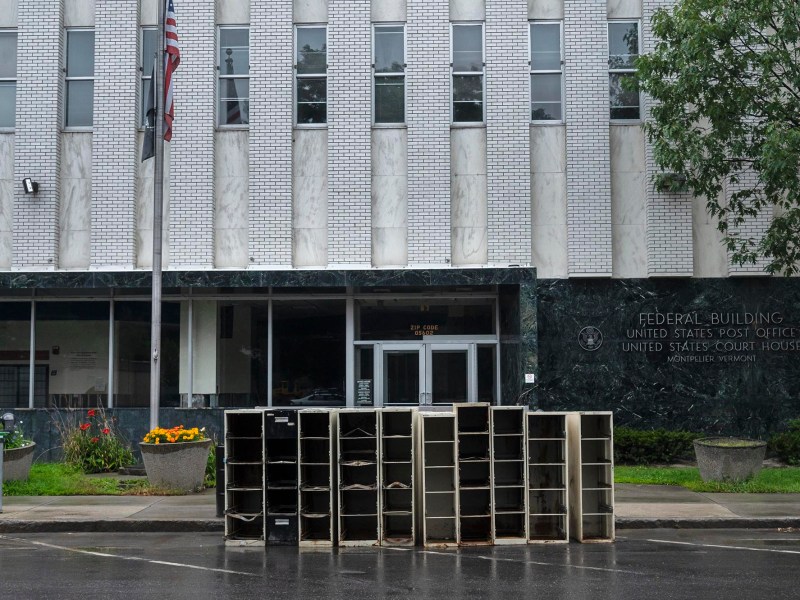 A group of metal boxes in front of a building.