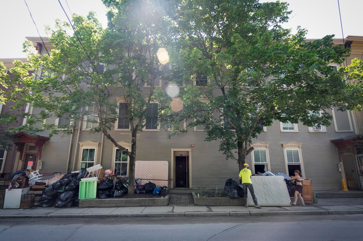a group of people standing in front of a building.